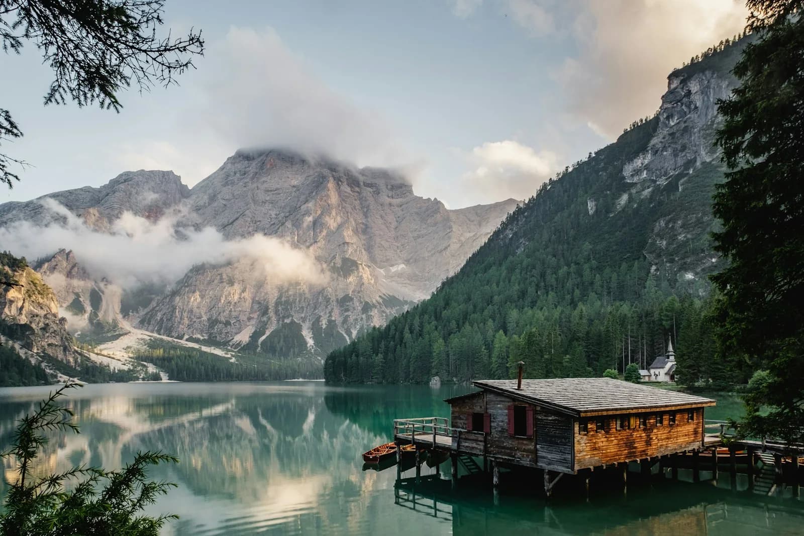 Alpine lake and distant mountain ridges in soft morning light