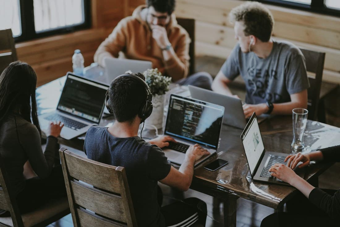 A small team sharing ideas around a laptop