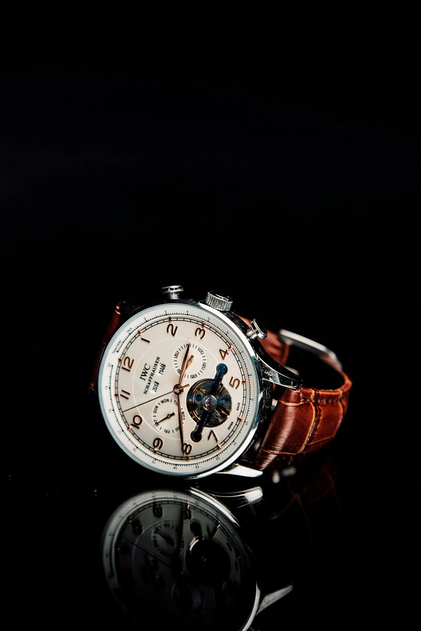 A carefully detailed wristwatch photographed in warm, subdued light
